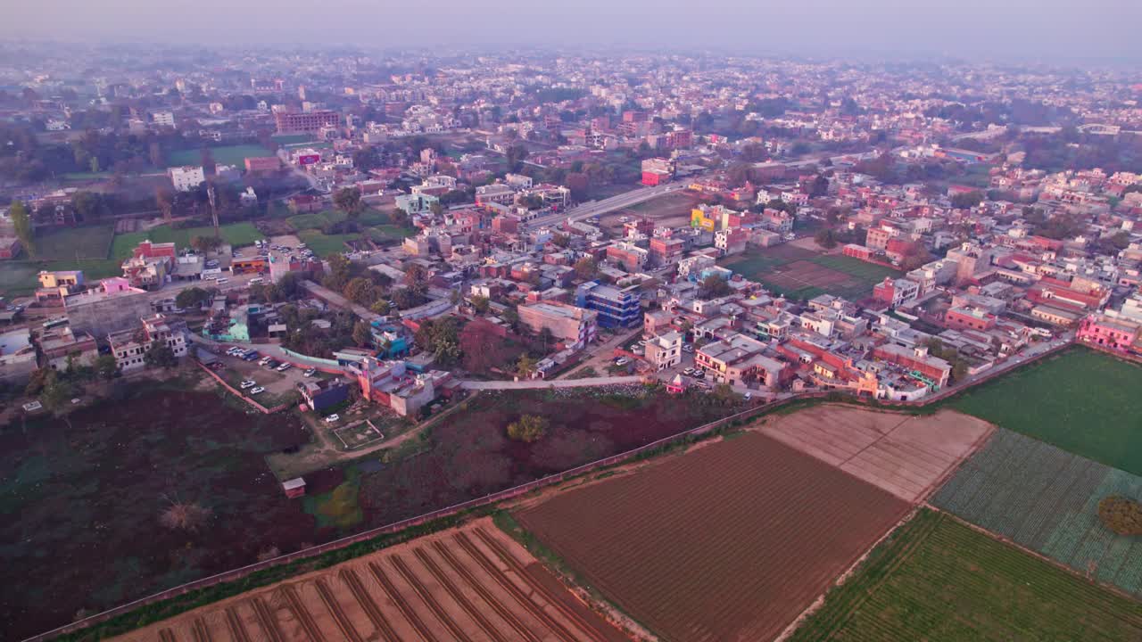 Crop field lands with city view and sky at Ayodhya, Uttar Pradesh, india. day time, push in, drone shot, 4k.