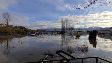Dolly-shot-reflections-on-water-surface,-Devastating-Floods-at-Abbotsford,-British-Columbia