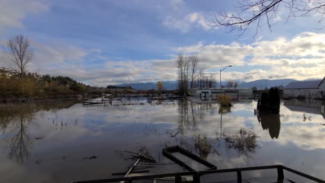 dolly shot reflections on water surface, devastating floods at abbotsford, british columbia