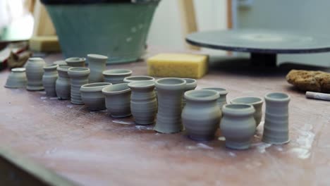 A-close-up-shot-of-some-raw-clay-pots-placed-on-a-table-outside-to-get-it-dried-under-the-sun-light