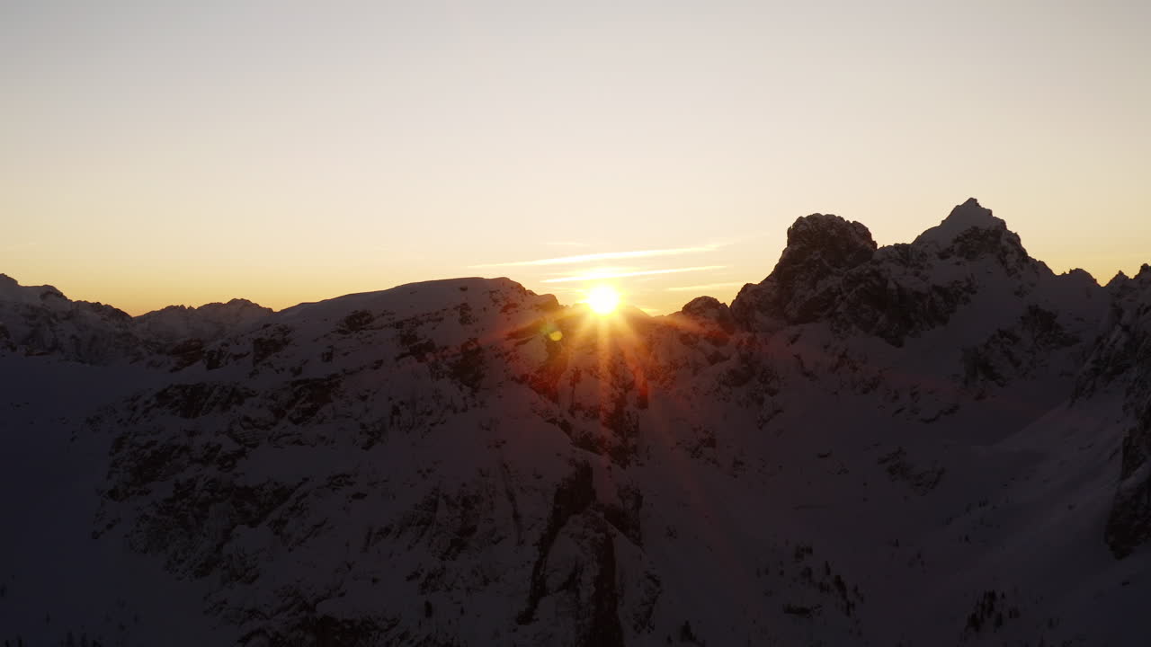 Winter Sunset over Snowy Mountain Peaks