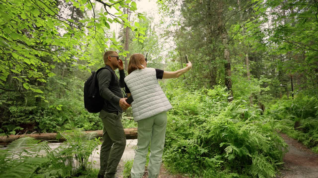Couple taking a selfie in a forest