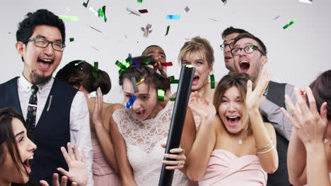 multi ethnic group of people party poppers slow motion wedding photo booth series