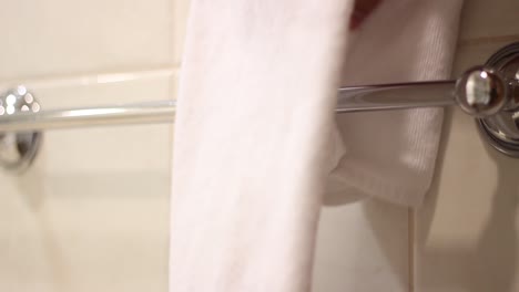 closeup shot of housekeeper placing clean bath towels in the bathroom 4