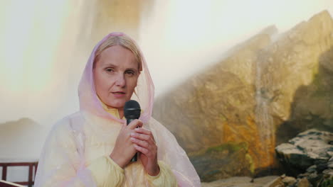 Woman-by-Waterfall-With-Microphone