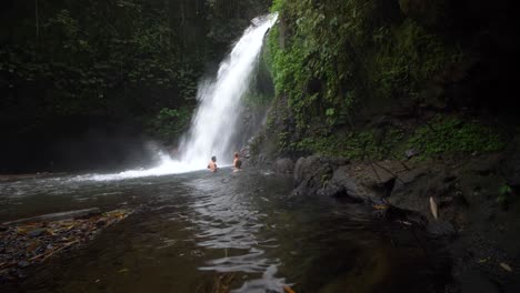 Reveal-Shot-of-Bathers-by-a-Waterfall