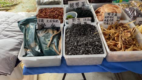 array of traditional chinese dried food in baskets at a local market