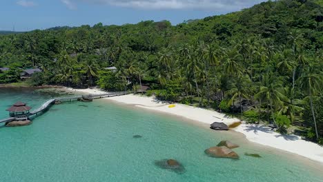 backwards aerial of a perfect tropical private beach in asia