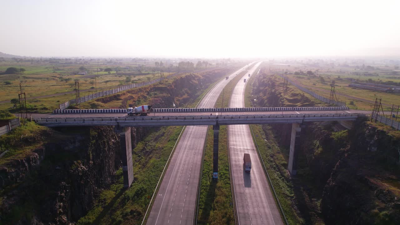 Mumbai Nagpur Expressway through greenfields under dense hazy sky due to air pollution, Maharashtra, Drone shot