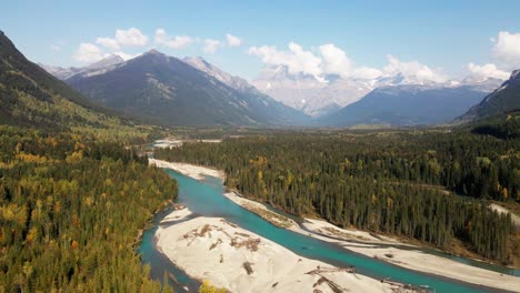 majestic-dolly-backward-wide-shot-of-Mount-Robson-Provincial-Park-in-the-autumn-on-a-mix-of-sun-and-clouds-day-with-mountains-in-the-background-and-the-Fraser-River-in-front-surrounded-by-forest