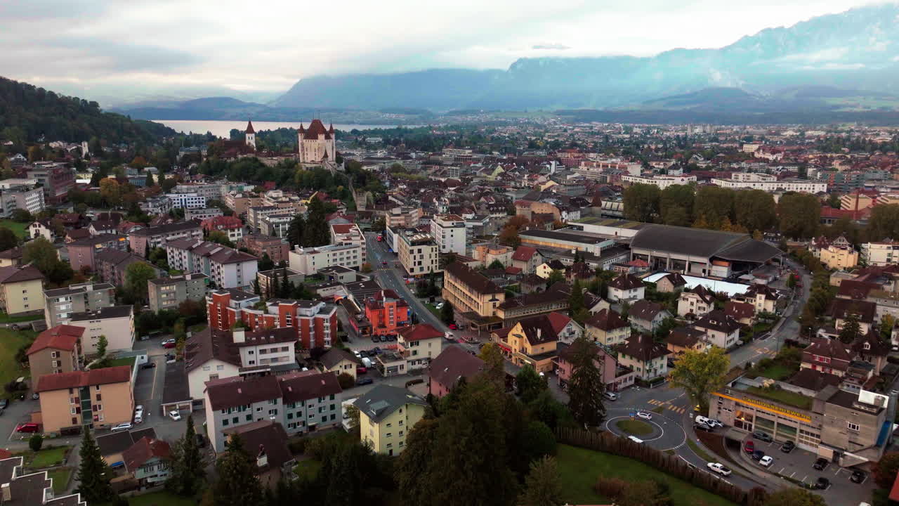 Aerial cinematic drone Thun Bern Switzerland Swiss village city downtown lake cars stunning Thun Castle Dukes of Z&auml;hrigen Interlocken Jungfrau cloudy sunrise sunset forward slowly pan up movement