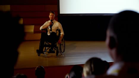 Young-Caucasian-disabled-businessman-speaking-in-business-seminar-in-auditorium-4k