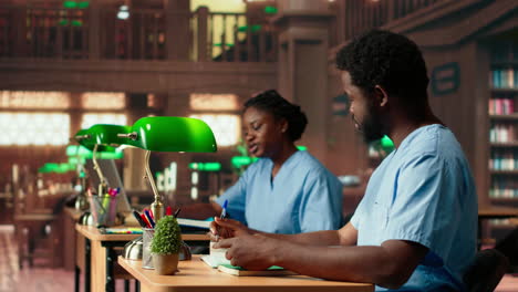 black med school students team reading anatomy textbooks and class notes