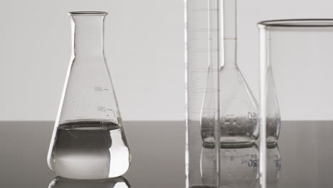 video of glass laboratory beakers and dishes with copy space on white background