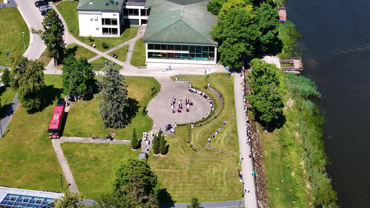 Folk dance of Latvia show in Birstonas township, aerial orbit view