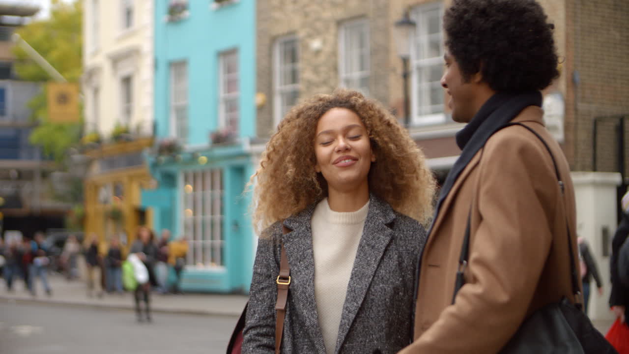 Stylish Young Couple Talking On City Street