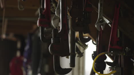 Close-Up-View-of-Various-Hanging-Clamps-in-a-Workshop-Setting