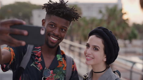 portrait happy multi ethnic couple using smartphone taking selfie photo smiling enjoying vacation together slow motion