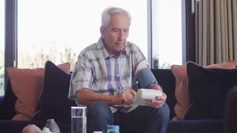 video of focused caucasian senior man checking pressure