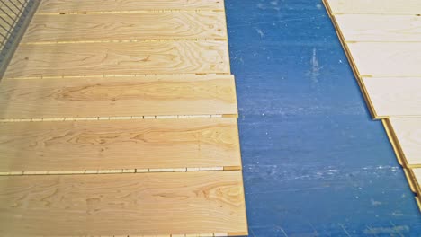 ?lean and smooth boards is going through all the processing steps for getting the final result of parquet for sale on the market. close-up.