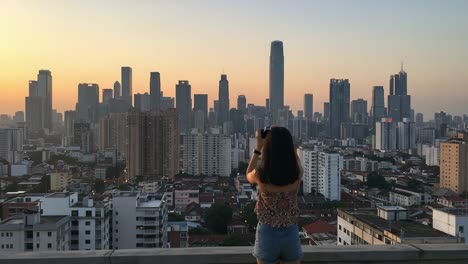 a cityscape sunset: capturing the beauty of urban skyline from rooftop as lights begin to twinkle and the horizon glows