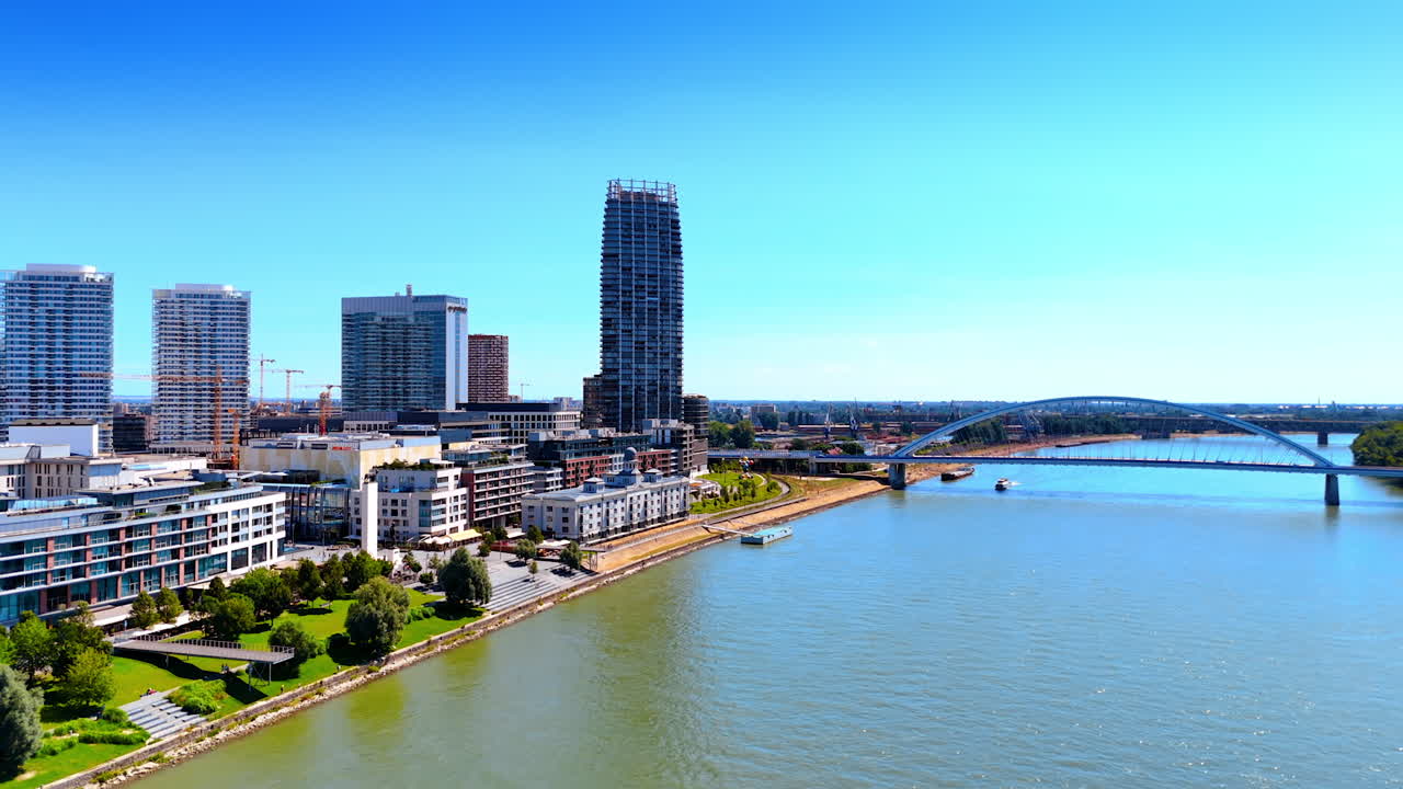 Flight over the Danube River crossing Bratislava, Slovakia. View on the Bridge of the Slovak National Uprising with a boat under it.