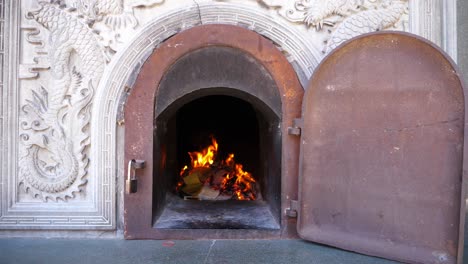 burning spirit money paper in a  ghost money stove