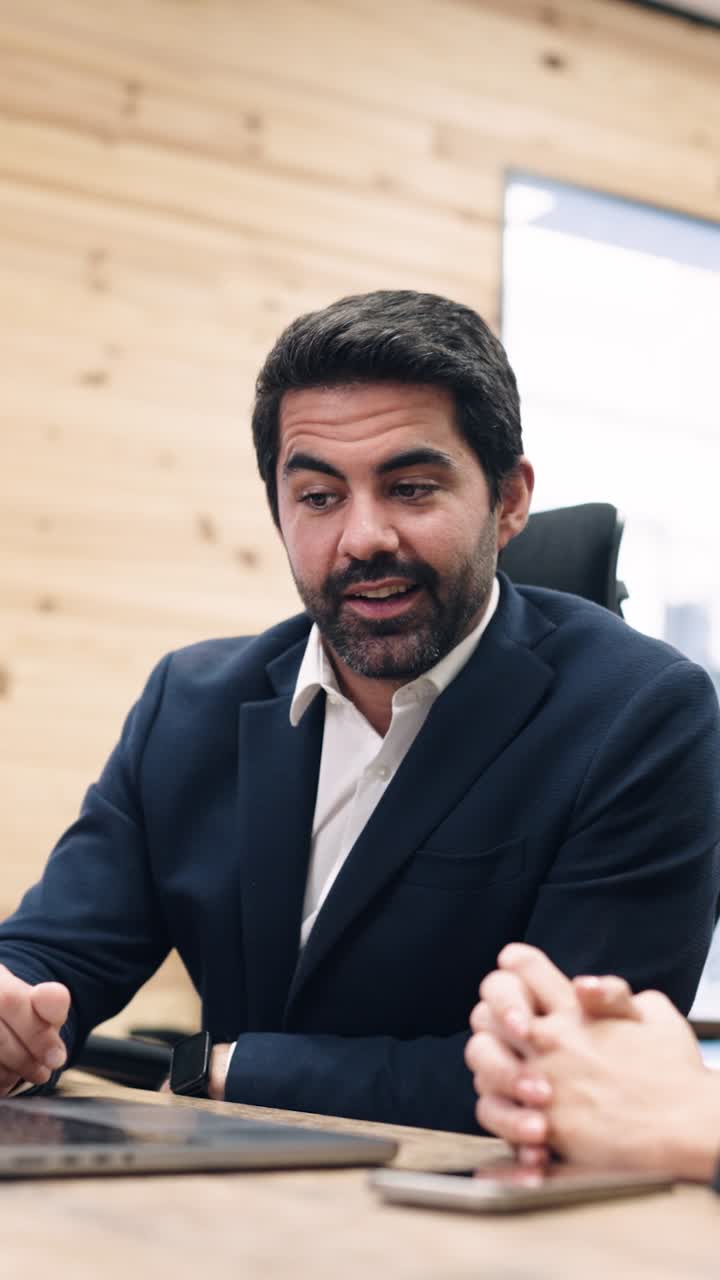 Professional Man in Suit Talking and Gesturing During Business Meeting