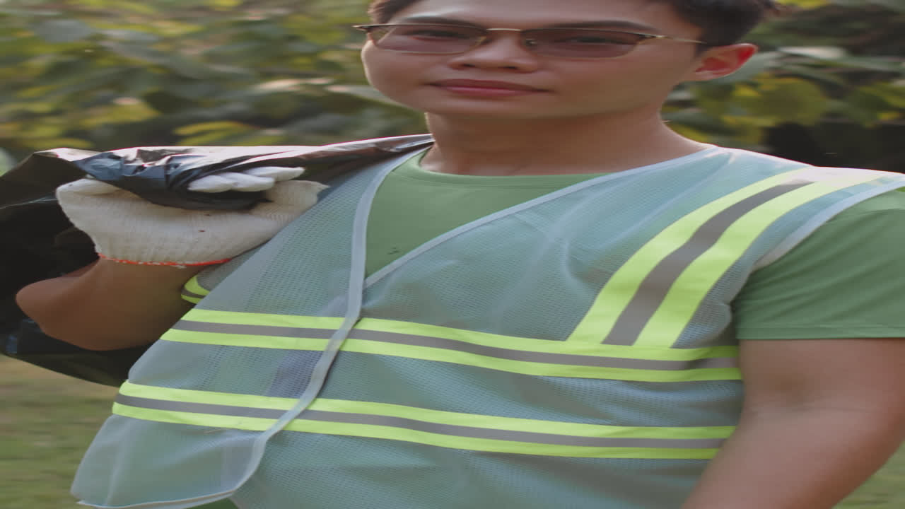 Portrait of Male Asian Zoomer with Bag of Collected Litter