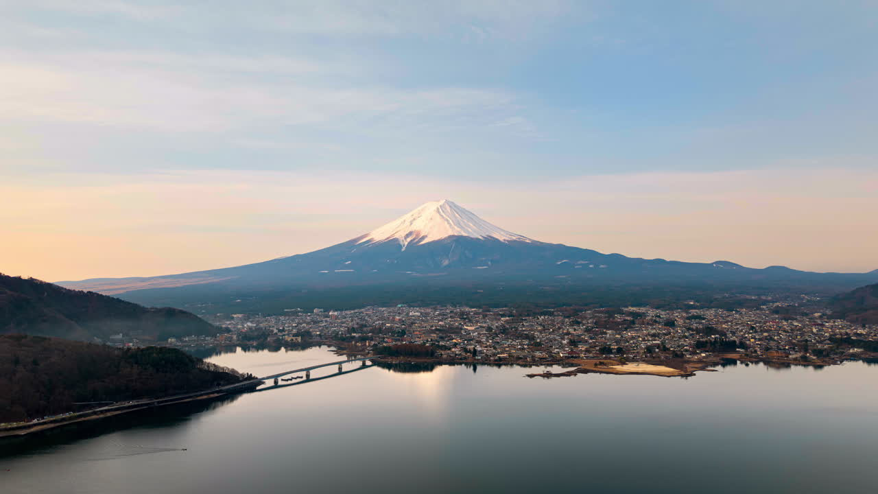 Aerial drone view of Lake Kawaguchiko near the Fujikawaguchiko town, Japan with Mount Fuji on the background time lapse