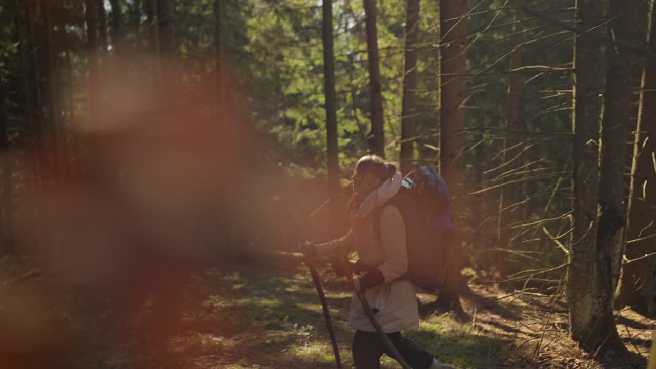 Woman hiking in the forest with a backpack