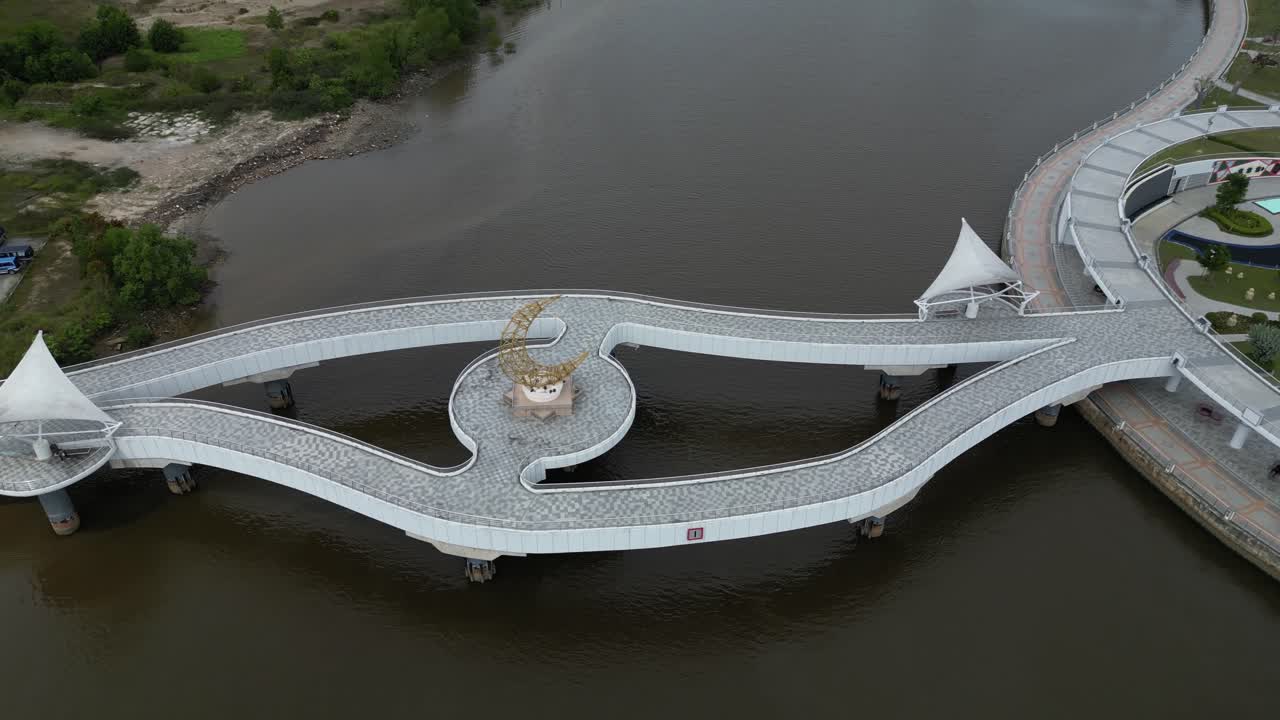 tomada aérea de un avión no tripulado de un puente peatonal que conduce hacia la mezquita del sultán omar ali saifuddien en bandar seri bagawan en brunei darussalam