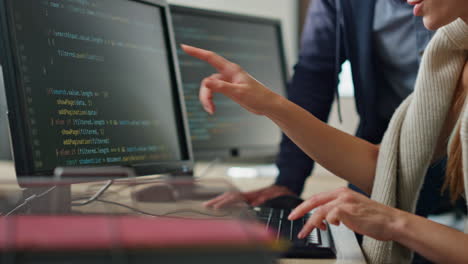 it programmers discussing project in office closeup. hands typing computer code