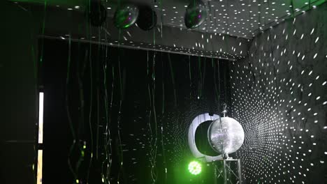 the disco ball mirror spins and reflects the light at the disco in the club.