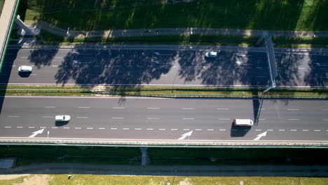 aerial view of cars driving in the highway on a sunny day