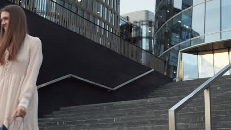 woman sliding down handrail outdoors