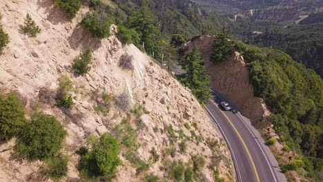 aerial view of cars driving through road bend