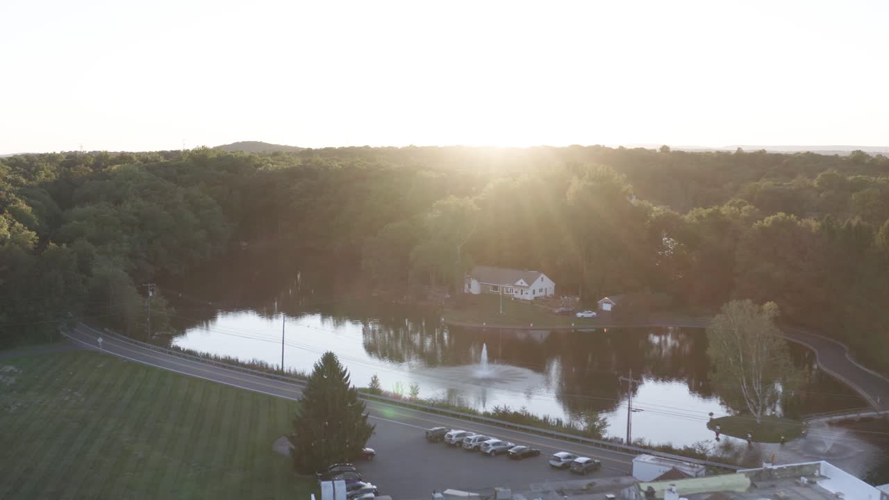 Aerial View of a House on a Lake at Sunset