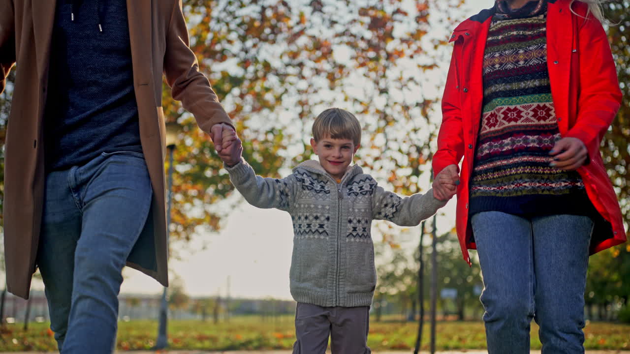 Family having fun in the park during autumn