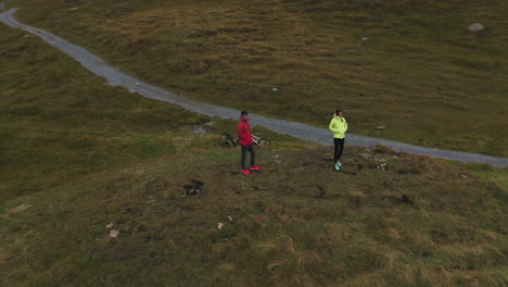 couple standing on ridge above lake bachalpsee in switzerland as drone orbits around them