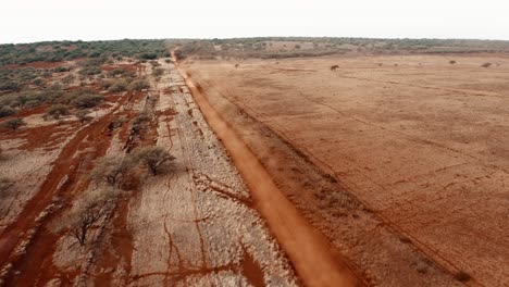 Vista-Aérea-over-cars-traveling-on-a-generic-rural-dirt-road-on-Molokai-Hawaii-from-Maunaloa-to-Hale-o-Lono-1