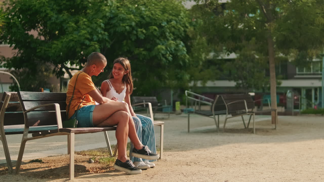 Mother and Daughter Talking on Park Bench