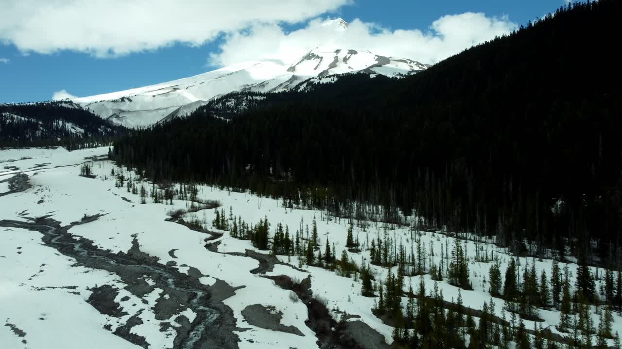 US, Oregon, Mt Hood, White River, 2025-04-22 - Drone view of the frozen river that comes down from Mt Hood. On a beautiful spring day.