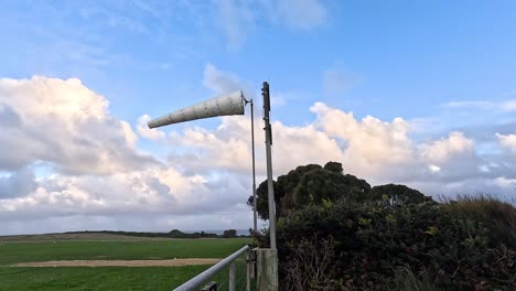 windsock blowing in the wind, scenic landscape