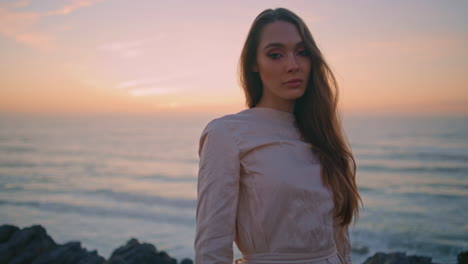 travel girl walking evening hill at ocean view. serene woman looking camera