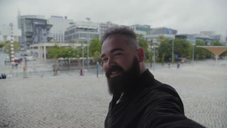 handsome bearded man posing for selfie.