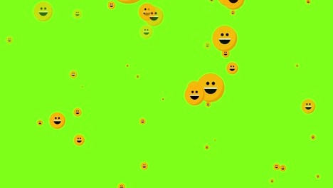 animated flying laughing emoji particles on green background