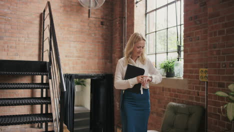 Business-woman-team-leader-walking-through-busy-office-meetings