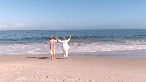 mature couple running and holding hands