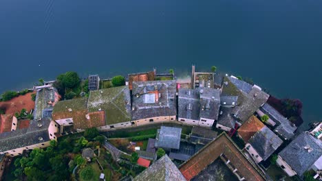 drone shot in orta san giulio historic building by lake orta in italy